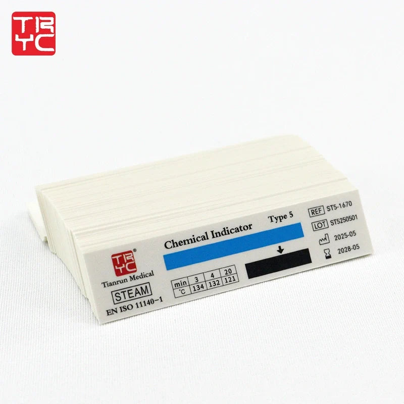 Class 5 steam chemical integrator strips stacked on a bench, with Type 5, STEAM and EN ISO 11140-1 printed on the strip beside the response window