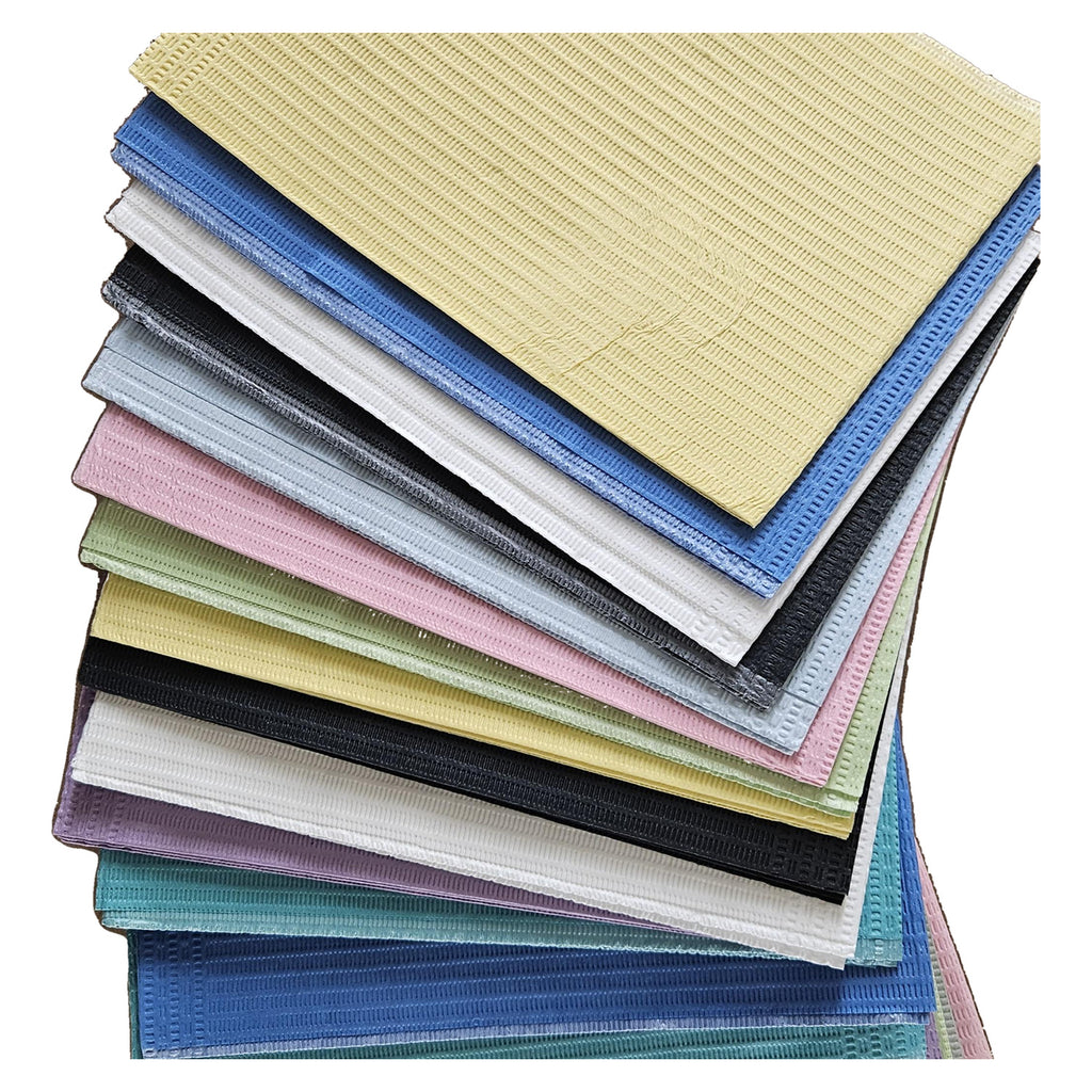 Aurelia dental bibs, assorted colours, layered close-up of a fanned stack of multiple bibs